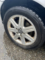 Close-up of the alloy wheel on a 2006 Volvo S40 showing wear and the MATRIX tire brand.