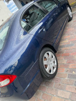 2009 Honda Civic LX FWD in blue color, showing clean body and good condition, parked on a cobblestone surface.
