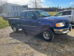 1998 Ford F150 XLT extended cab 4X4 with 79,412 miles, blue exterior, parked on gravel