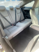 Interior view of the rear seats in a 2014 Honda Civic EX coupe with seatbelts.